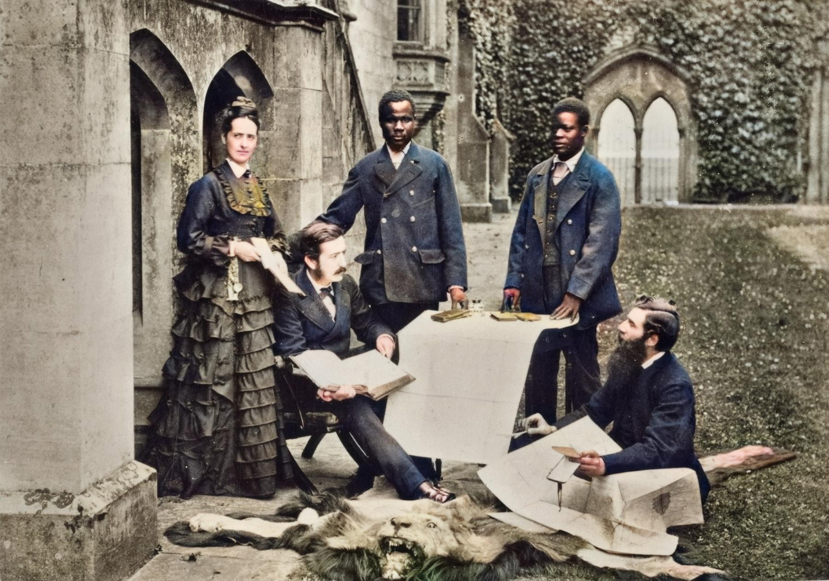 Colorised version of R. Allen & Sons, “Agnes and Thomas Livingstone (Daughter and Son of David Livingstone), Abdullah Susi, James Chuma, and Rev. Horace Waller at Newstead Abbey, Nottingham, Discussing the Journals, Maps, and Plans Made by the Late David Livingstone” (1874). SOAS Library, University of London. Copyright Council for World Mission. Used by permission for private study, educational or research purposes only.